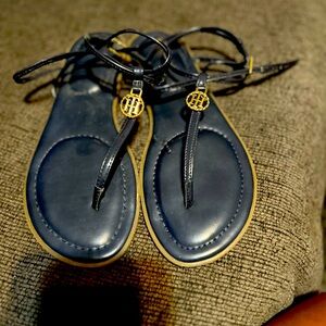 Navy blue Tommy Hilfiger sandals with gold trim.